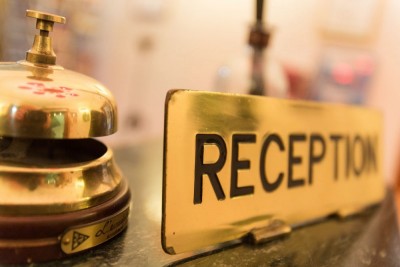 photo of a hotel reception desk and bell
