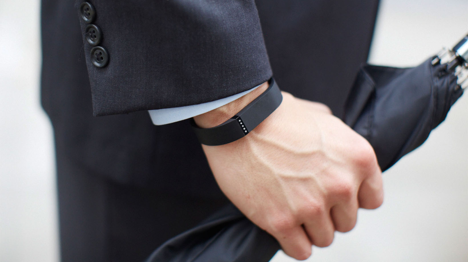 close up picture of a fitbit on a man's wrist