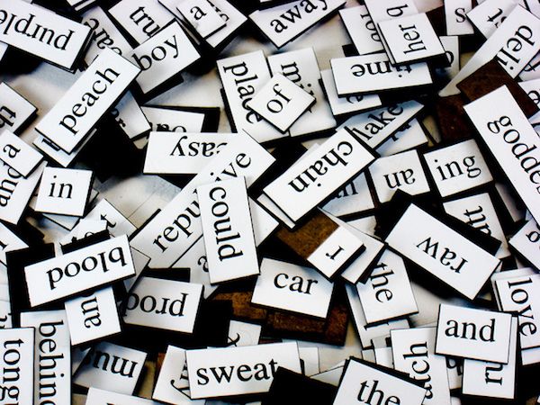 photo of a jumble of magnetic poetry words