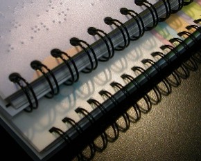 Braille volumes made with wire bindings.