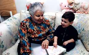 Picture of adult & small child reading braille book