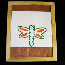 Photo of drawing board with drawing of a butterfly on it.