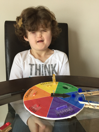 Girl smiling with color wheel game