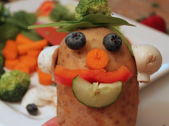 home-made mr potato head has blueberry eyes, mushroom ears, etc...