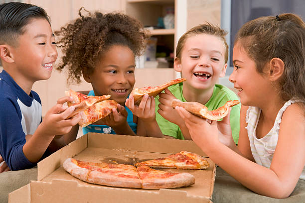kids sharing slices of pizza