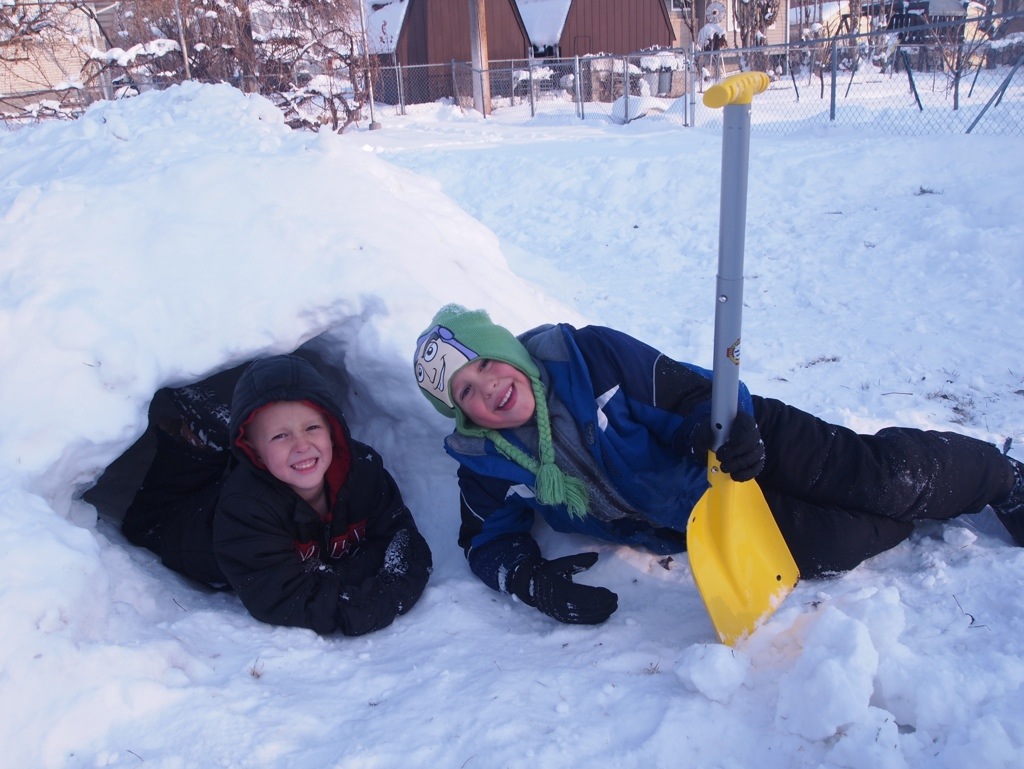 Kids inside a snow fort