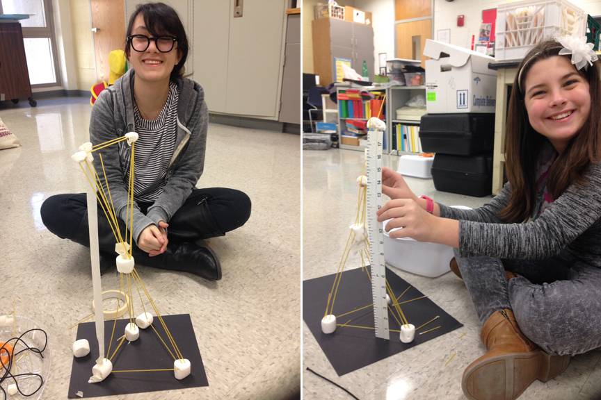 Two students show off their towers