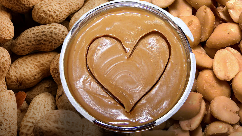 photo of a bowl of peanut butter sitting on peanuts