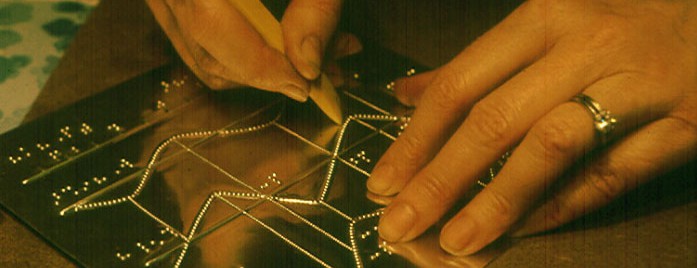 close up photo of hands creating a master for tactile map