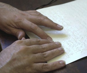 A proofreader checks braille both for typographical errors and machine-related errors