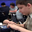 Young boy using a braille notetaker.