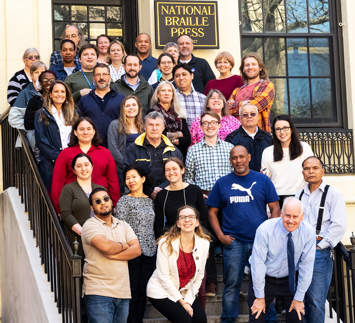 NBP's staff stands in front of our building at 88 Saint Stephen Street in Boston