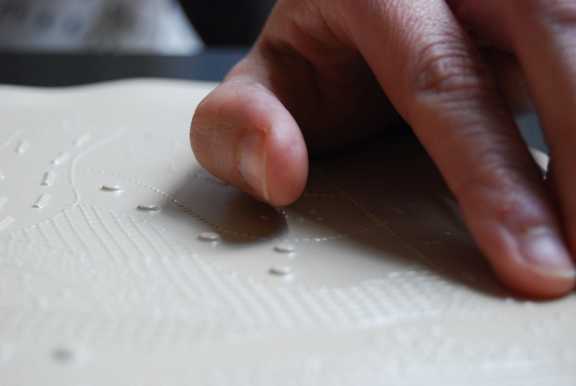 Closeup of hands reading a tactile graphic