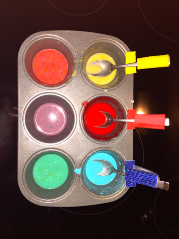 Photo of a muffin tin with 6 colors mixed and ready for use.