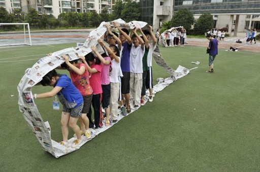 Kids inside the newspaper caterpillar wheel!