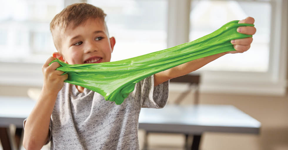 boy pulls green slime