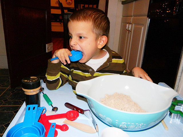 Blind boy playing with measuring cups