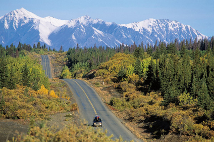 photo of a car riding on a winding road