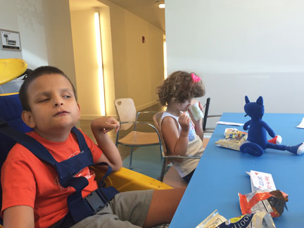 Blind boy and girl enjoy snacks with Pete doll.