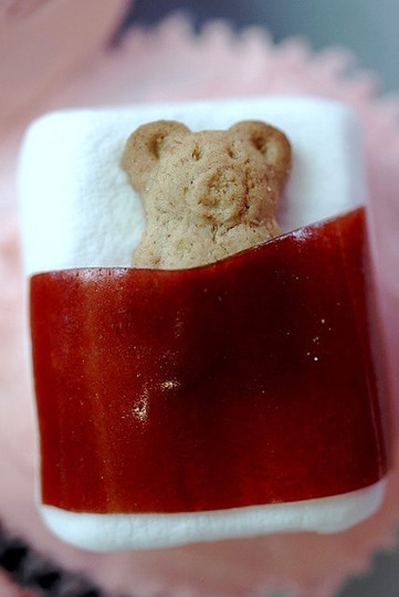 Teddy graham cracker naps on a marshmallow with a fruit rollup sheet
